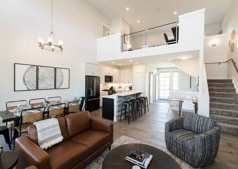 Relax in your spacious open-plan living area with soaring ceilings, where leather seating create the perfect space for gathering.