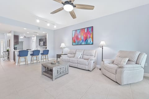 MB102 - Reclining sofa end seats & chair and large smart TV in the living. Sliding doors provide access to the screened in lanai