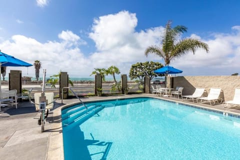 Dive into sunlit swims with sparkling pool and ocean views.