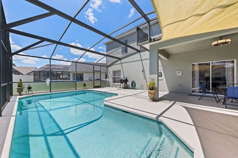 Sparkling private pool with screened patio, lounge chairs, and peaceful views.