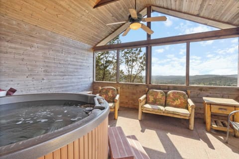 This hot tub room is the perfect spot to enjoy a relaxing dip in the tub while admiring the breathtaking views.