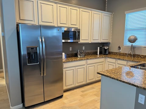 Kitchen with Keurig, ample counter space, and dishwasher. 
