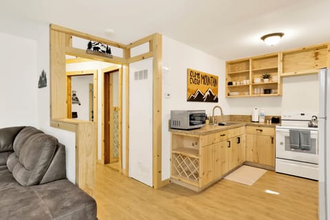 Fully equipped cabin kitchen with ample cabinetry, stove, fridge, microwave, and coffee maker—perfect for cooking meals, morning coffee, and feeling right at home on your stay.