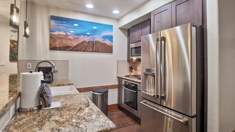 Modern kitchen with granite counters and appliances