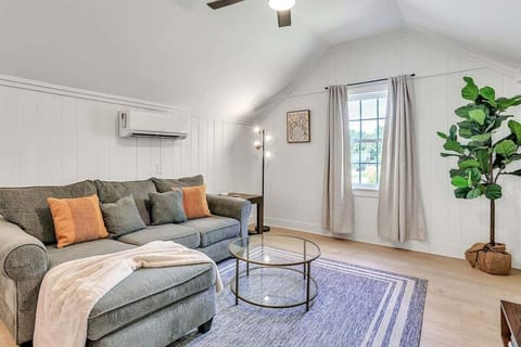 Tall ceilings and abundant natural light create an airy, inviting space—perfect for relaxing on the cozy sofa after a long day.