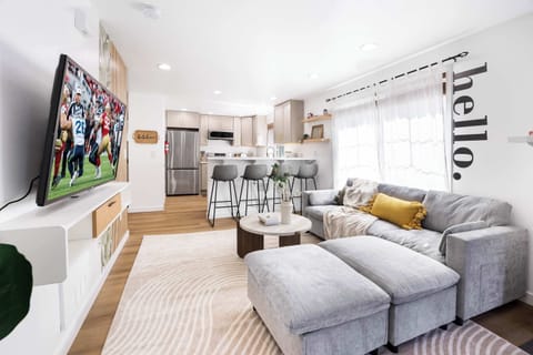 Cozy living room with large TV – Perfect for game day or movie nights, just steps from the kitchen.