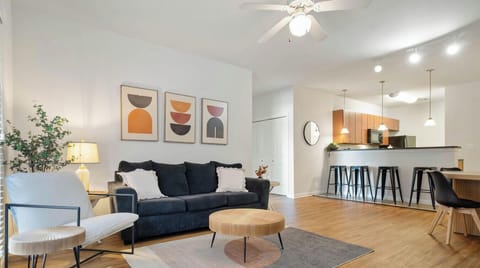 Lounge vibes: bold art, soft lighting, and a couch that’s basically calling your name.