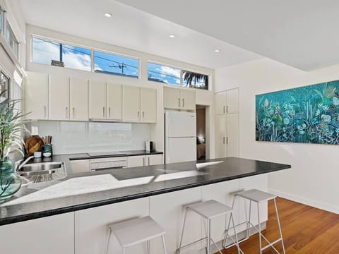 Perch at the island bench with a Nespresso and your travel journal as soft morning light streams into the space.