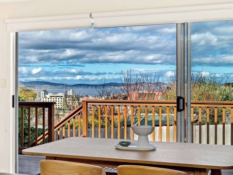 Enjoy every meal with a view, as the dining table frames Hobart’s rooftops and the River Derwent stretching out beyond.