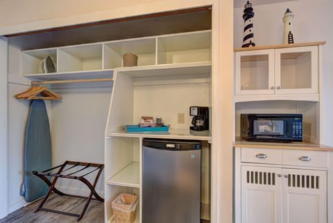 Convenience meets style in the thoughtfully designed nook, equipped with a mini-fridge, microwave, and essential amenities for a relaxing stay.