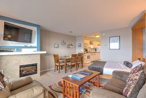 This inviting studio offers a full kitchen, complete with modern appliances, and a welcoming living area perfect for relaxation.