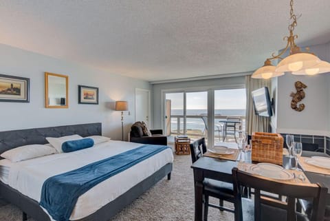 Experience breathtaking panoramic ocean views from this spacious studio featuring a luxurious king bed, a cozy kitchen, and a private patio for ultimate relaxation.