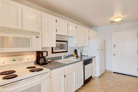 Bright and airy, the fully equipped kitchen offers easy access to the dining area and panoramic ocean views, making it an ideal space for a cozy meal or snack.