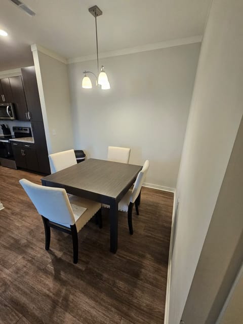 Bright dining space featuring a modern table and comfortable seating for family or business dining.