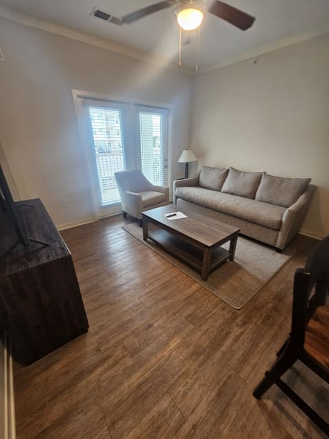 Modern living space featuring comfortable furnishings, large windows, and direct access to the private balcony.