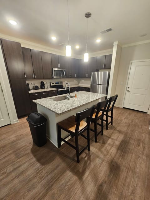 Modern kitchen featuring granite counters, stainless-steel appliances, and all essentials for your extended stay.