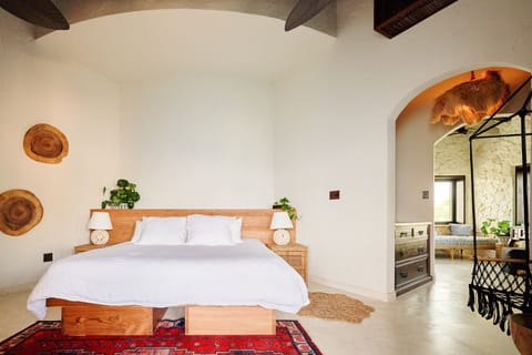 A bright, serene bedroom featuring warm natural tones and rustic décor.