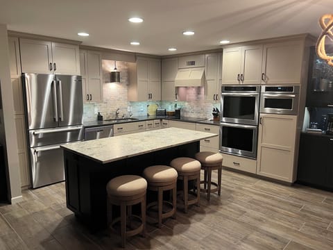Main level kitchen, fully equipped with SS appliances, dishes, and cooking items