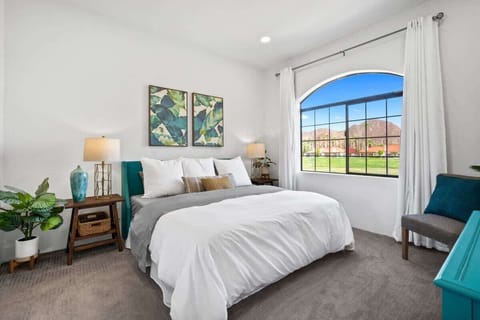 Spacious bedroom with large window and serene atmosphere