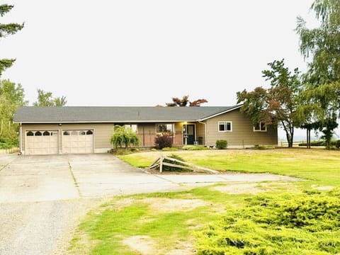 Private rural setting with spacious driveway, offering peace, privacy, and easy access to town.