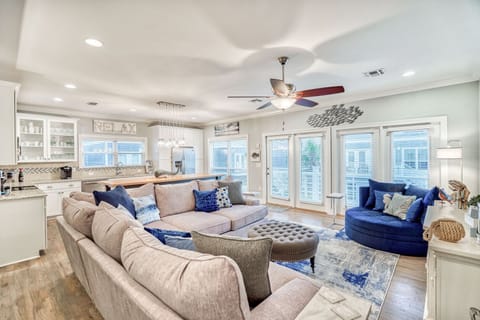 Living room: Large sectional, Smart TV (65”), balcony access