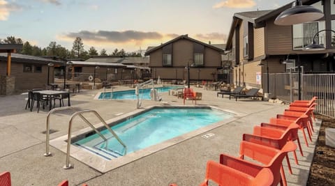 Unwind poolside on bright loungers beside the bubbling hot tub.