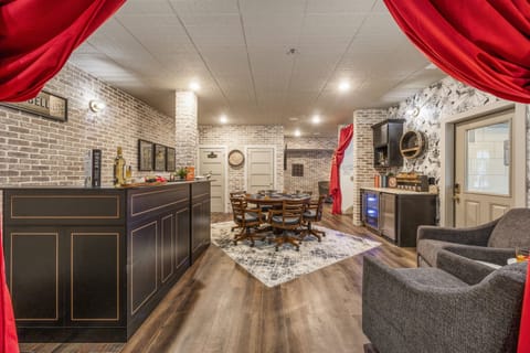 Host unforgettable evenings in this speakeasy-style entertainment lounge. With a poker table, private bar, and moody lighting framed by bold red drapes, it's an immersive space designed for fun, relaxation, and sophistication.