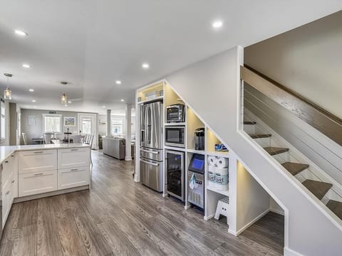 Contemporary kitchen with double ovens, beverage cooler, and expansive counters—crafted for family feasts and shared memories.