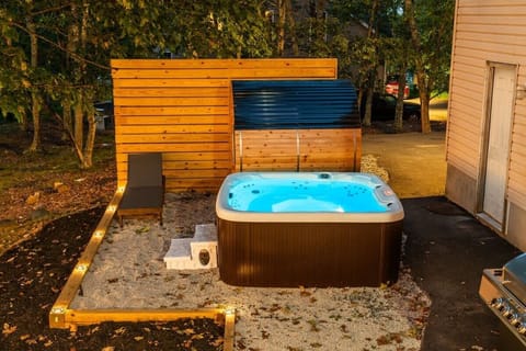 Unwind in the private hot tub beside a cozy barrel sauna, tucked among peaceful trees