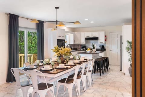 Gather around the spacious dining table in the bright open kitchen & dining area