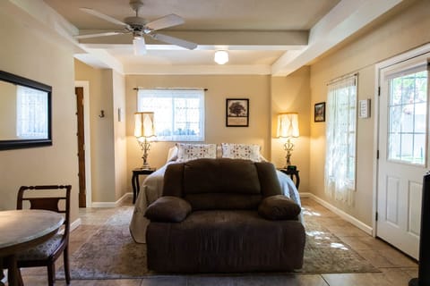 Cozy guest room with soft light, plush bedding, and inviting vintage charm
