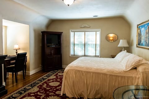 Spacious king bedroom—luxury bedding, vintage touches, and natural light