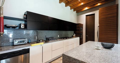 Fully equipped kitchen with microwave, oven, dishwasher, stove, and toaster