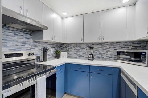 Bright kitchen with sleek cabinetry, double sink, and stainless steel appliances, fully stocked for easy at-home cooking.