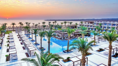 Sip sunset cocktails beside the palm-lined lagoon pool.