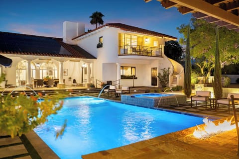 Experience vibrant nights; glowing waters meet a warm hearth.