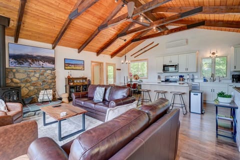 Our cozy den features an open floor plan with a gas fireplace, stunning views, a large TV, and a welcoming bar area — the perfect place to unwind.