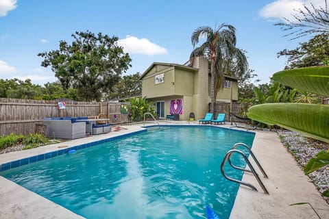 Completely private pool in fenced in patio wth outdoor seating and charcoal grill.
