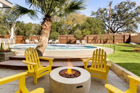 Poolside by day, fireside by night—this backyard was made for unforgettable moments.