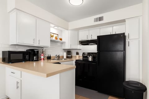 Fully equipped kitchen featuring full-size appliances and everything needed for home-cooked meals.