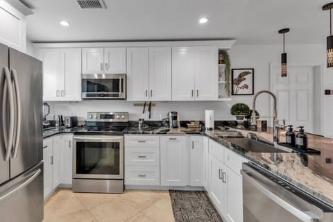 Kitchen area with all stainless steel appliances - microwave, Keurig pod coffee maker, dishwasher, range & refrigerator!