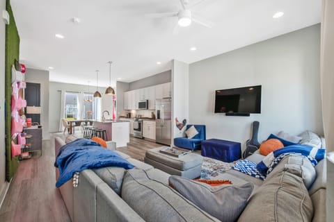 Large Great Room. Living room, dining room, kitchen, games, large TV and guitar.