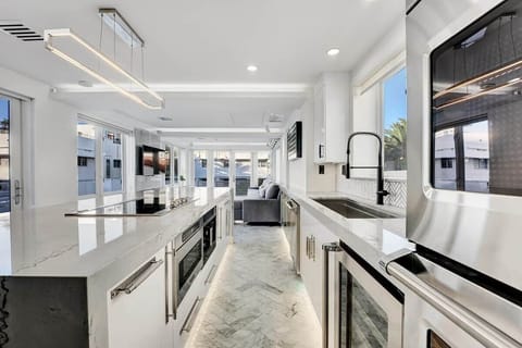 3rd FLOOR: KITCHEN. 30 foot island. Viking appliances (double oven, warmer, full fridge, wine fridge, dishwasher, drawer microwave, 6 burner cooktop with retractable vent, dishwasher), built-in Miele espresso machine. 48 inch sink. 