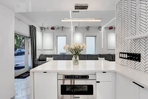 1st FLOOR: FULL BAR KITCHEN features full size Viking fridge, Viking drawer microwave, sink, ceiling mounted champaign flutes, and a bar for 2. Multicolor lights are controllable via remote. Hidden disco ball reveals from upper cabinets via remote. 
