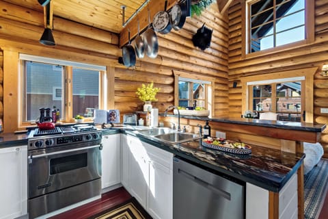 Cook with ease in a chef’s kitchen framed by rustic log cabin charm