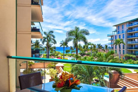 HKH-323 Spectacular resort view with winding pools, palm trees, and turquoise ocean just beyond your private lanai