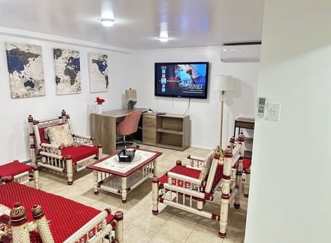 Loving room with smart tv and feet and massage chair.
