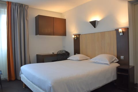 Relax in a bright room with bedside sconces and workspace.