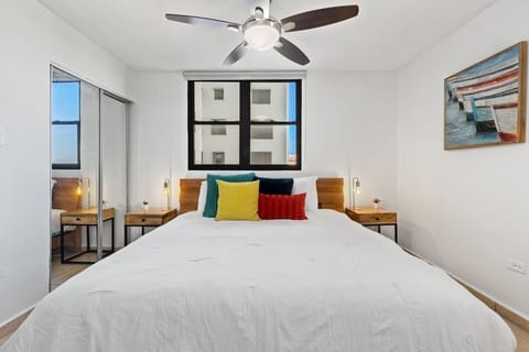 Bright bedroom with natural light and a soothing ceiling fan.
