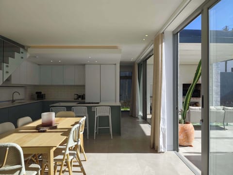 Open-plan dining and kitchen leading out to patio